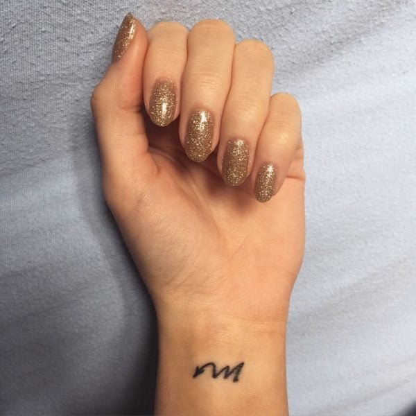 Minimalist Scorpio Symbol Wrist Tattoo.