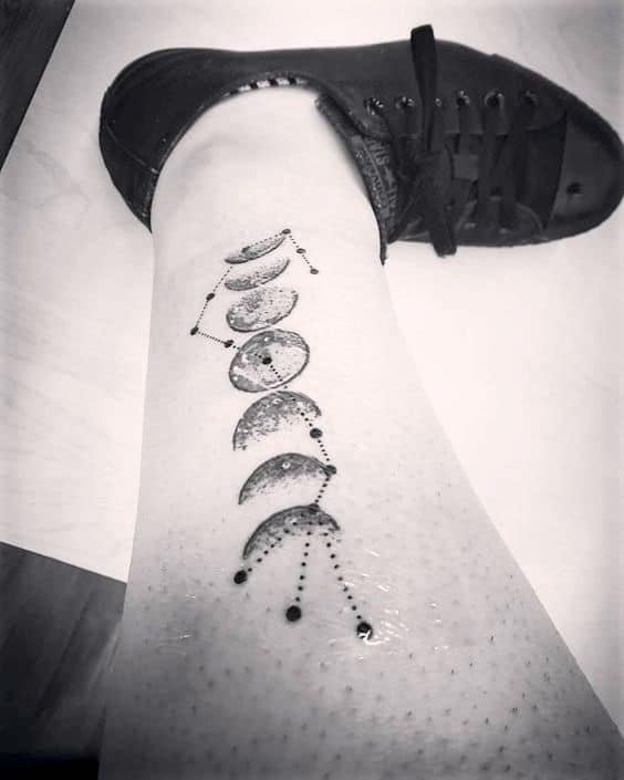 Moon phase tattoo combined with Scorpio constellation.