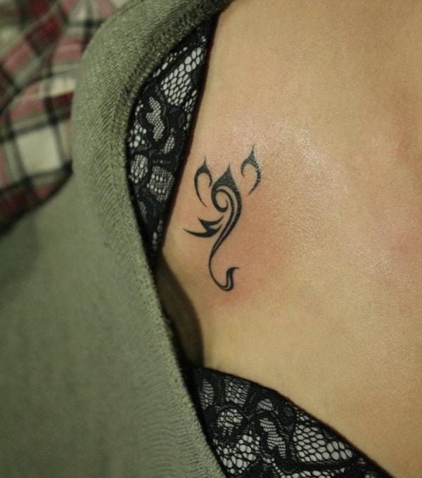 Tribal Scorpion Breast Tattoo.