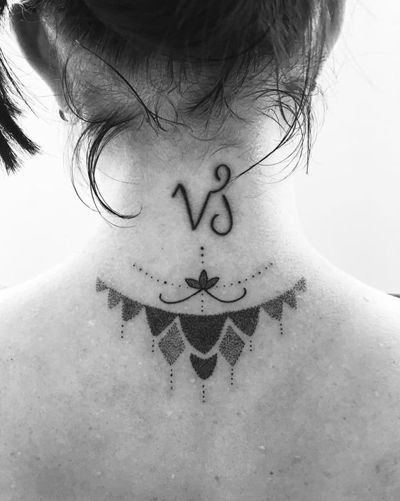 A lotus and Capricorn symbol tattoo in a tribal style