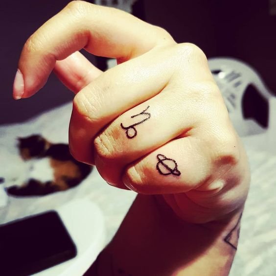 Capricorn and Saturn finger tattoos