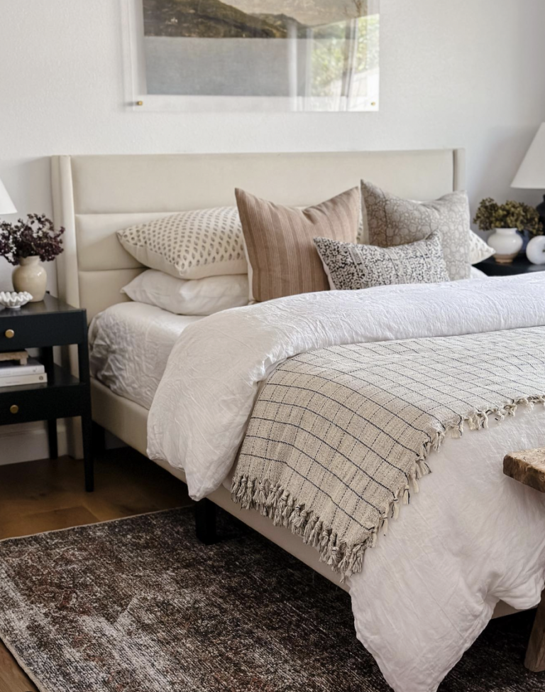 Neutral Color Bedding And Carpet On Dark Wood Floors