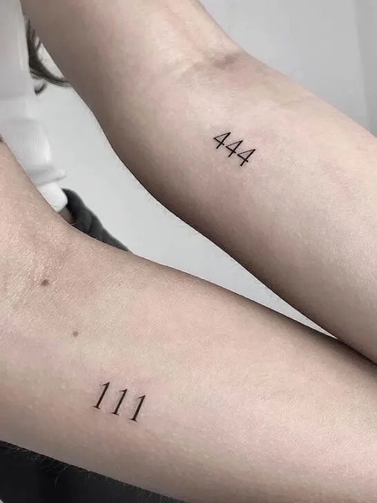 Matching angel number tattoos on the forearm