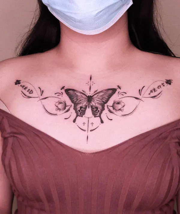 Black and grey butterfly chest tattoo
