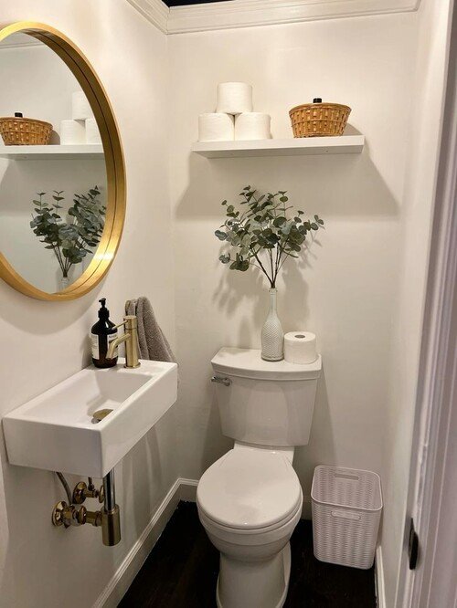 Gold-framed mirror with practical decor