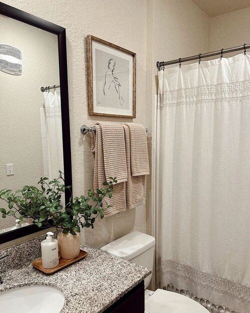 Cream shower curtain and artwork