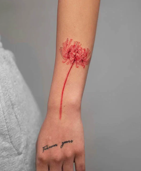 Elegant red spider lily forearm tattoo