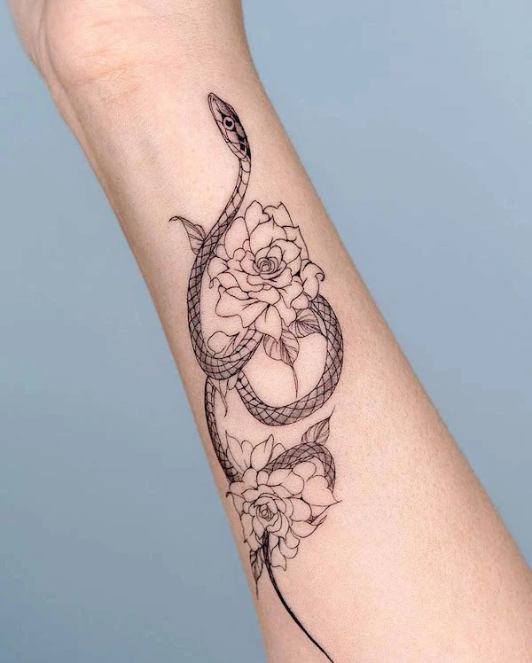 Floral snake forearm tattoo