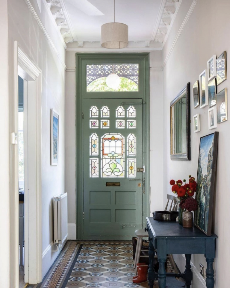 Green Front Door With Unique Tile Flooring
