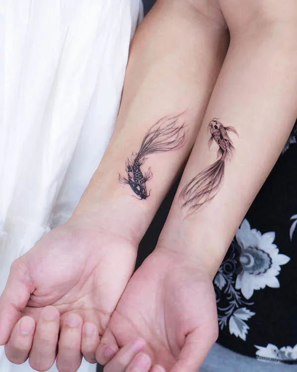 Matching koi fish forearm tattoos