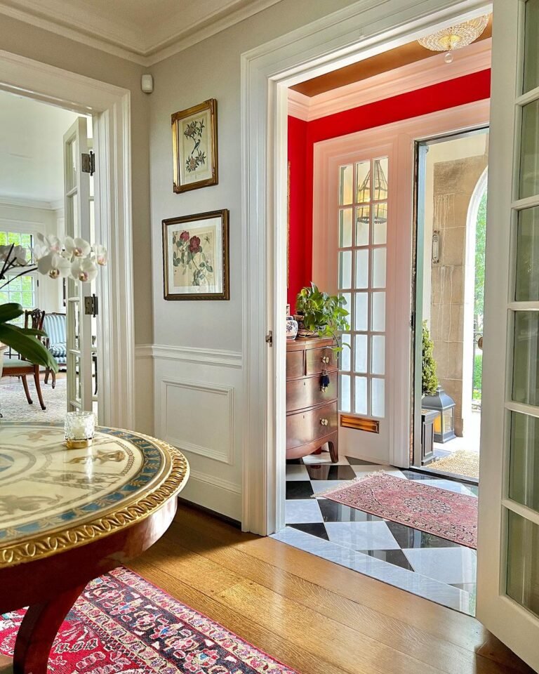 Red Accent Wall And Checkerboard Flooring