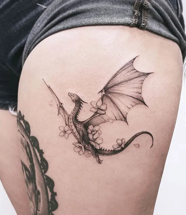 Floral dragon thigh tattoo