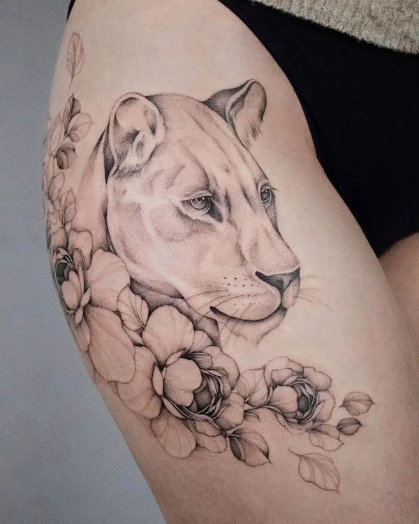 Lion and flower thigh tattoo for women