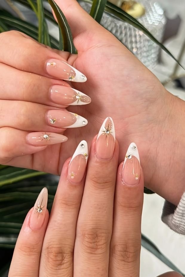 Glamorous French Tip Nails with Rhinestones and Luxe Accents